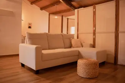 a living room with a couch and a stool at MonResidence La Figuereta in Manresa