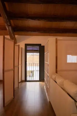 a room with partition walls and a door with a window at MonResidence La Figuereta in Manresa