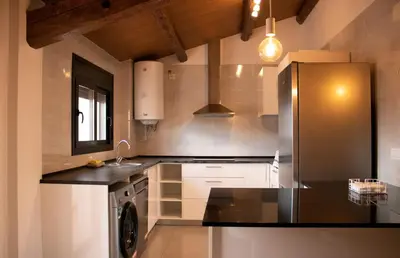 a kitchen with a refrigerator and a sink at MonResidence La Figuereta in Manresa