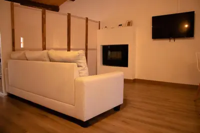 a white couch in a living room with a flat screen tv at MonResidence La Figuereta in Manresa