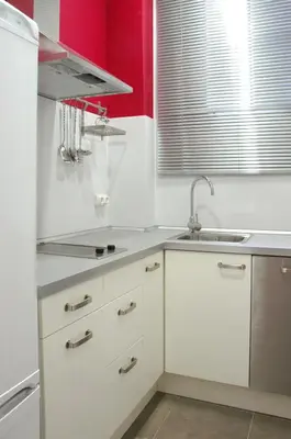 a kitchen with white cabinets and a sink at Barcelonaguest in Barcelona