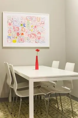 a white table with white chairs and a vase on it at Barcelonaguest in Barcelona