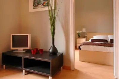 a bedroom with a desk with a computer and a vase at Barcelonaguest in Barcelona