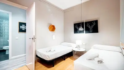 two beds in a room with a mirror at Magnificent 4 bedroom apartment in Eixample in Barcelona