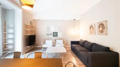 a living room with a couch and a table at Magnificent 4 bedroom apartment in Eixample in Barcelona