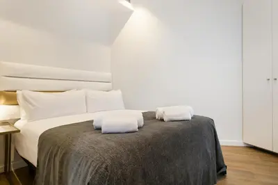 a bedroom with a bed with two towels on it at Vale Suites in Barcelona