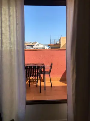 a table and a chair on a balcony at Vale Suites in Barcelona