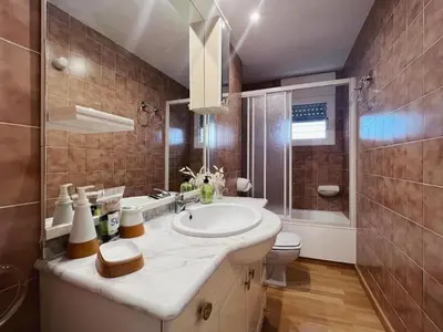 a bathroom with a sink and a toilet at Hauzify I Apartament Can Reig in San Pol de Mar