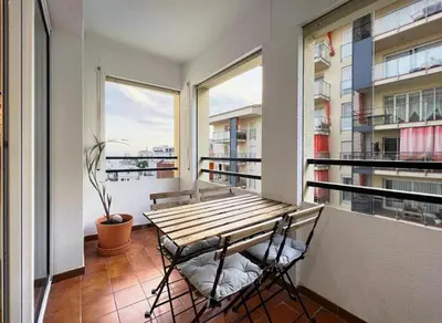 a balcony with a wooden table and two chairs at Hauzify I Apartament Can Reig in San Pol de Mar