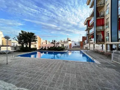 a swimming pool in the middle of a building at Hauzify I Apartament Can Reig in San Pol de Mar