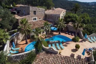 an aerial view of a villa with a swimming pool at Sitges Hill Retreats-Masia Nur 22 bedrooms divided over 9 houses for max 44 guests in Canyelles