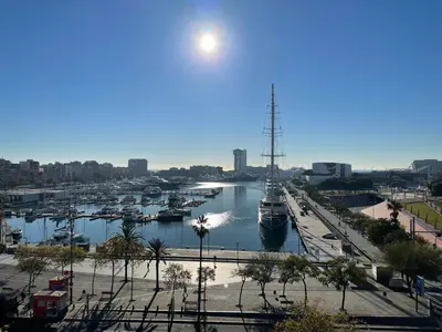 a harbor with boats docked in a city at Som Nit Port Vell in Barcelona