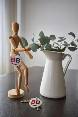 a small wooden figurine standing next to a vase at BBarcelona Diputació Flat in Barcelona