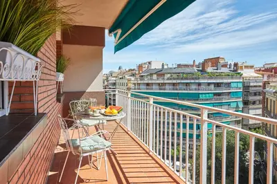 a balcony with a table and chairs and a view of a city at BBarcelona Diputació Flat in Barcelona