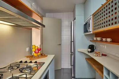 a small kitchen with a stove and a refrigerator at BBarcelona Diputació Flat in Barcelona