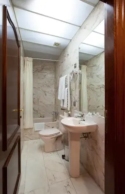 a bathroom with a toilet and a sink at Alba Hotel in Barcelona