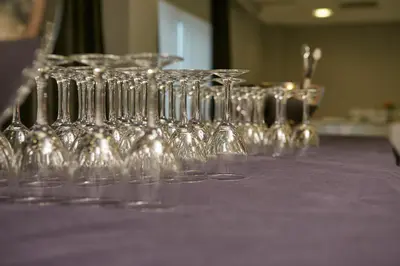 a group of wine glasses sitting on a purple table at Sercotel Ciutat de Montcada in Montcada i Reixac
