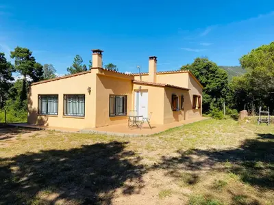a small house with a picnic table in front of it at Refugio en el Parque natural del Montseny in El Brull