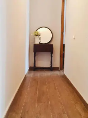 a hallway with a mirror and a wooden floor at Refugio en el Parque natural del Montseny in El Brull