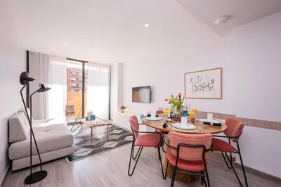 a living room with a dining room table and chairs at Sweett - Casa Fira in Barcelona