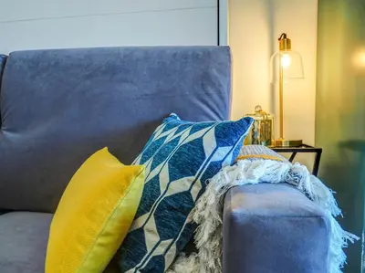 a blue couch with pillows on it at The Beach Studio by Hello Homes Sitges in Sitges