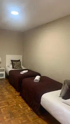 a room with two beds with brown and white sheets at Somnio Hostels in Barcelona
