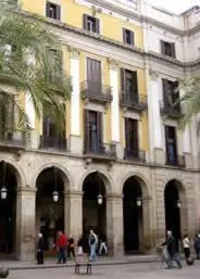 a large building with people walking in front of it at Roma Reial in Barcelona