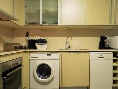 a kitchen with a washing machine and a sink at Vale Beach in Barcelona