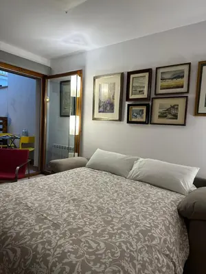 a bedroom with a bed and some pictures on the wall at Chic apartment beach in Mataró
