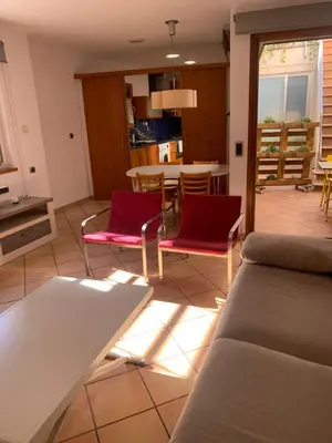 a living room with a couch and chairs and a table at Chic apartment beach in Mataró