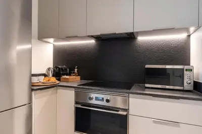 a kitchen with a stove and a microwave at Arrivo Apartments in Barcelona