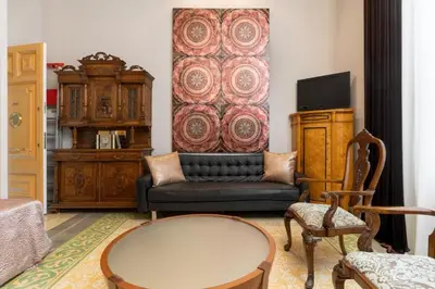a living room with a couch and a tv at El Petit Palauet in Canet de Mar