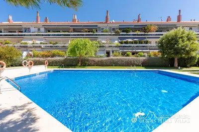 two beds in a room with a balcony at Apt Parc Del Mar in Sitges very near Beach in Sitges
