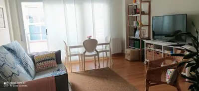 a living room with a couch and a television at Studio doria in Sant Boi del Llobregat