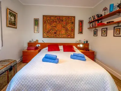 a bedroom with a large white bed with blue pillows at Apartment Millenium by Interhome in Premia de Dalt