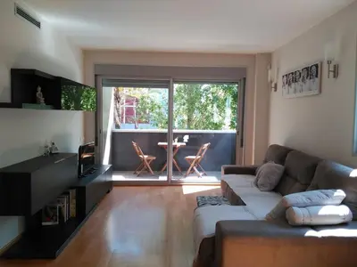 a living room with a couch and a table at 3 BEDROOMS, 2 BATHROOMS FOR 6 PAX, SWIMMING POOL, FREE PARKING and NEAR THE BEACH! in Sant Adria de Besos