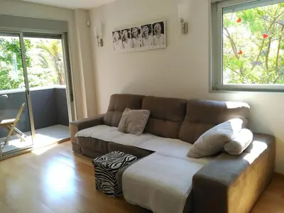 a living room with a couch and a window at 3 BEDROOMS, 2 BATHROOMS FOR 6 PAX, SWIMMING POOL, FREE PARKING and NEAR THE BEACH! in Sant Adria de Besos