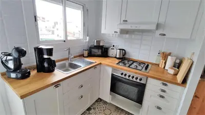 a kitchen with a sink and a stove top oven at EMILY BEACH-CITY Apartment in Montgat