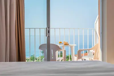 a room with a bed and a view of the ocean at Checkin Catalonia in Calella