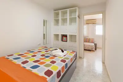 a bedroom with a large bed in a room at Barcelona Sunny Terrace in Hospitalet de Llobregat