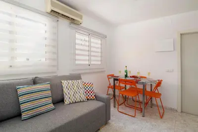 a living room with a couch and a table at Barcelona Sunny Terrace in Hospitalet de Llobregat