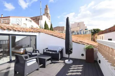 a patio with chairs and a umbrella on a roof at Marina Vila House, Masnou in Masnou
