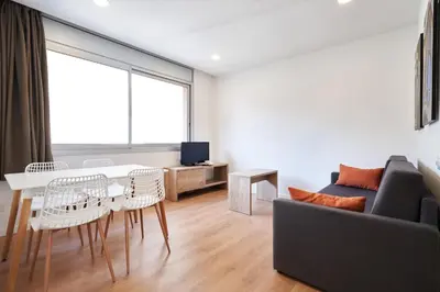 a living room with a table and a couch at Aparthotel Augusta in Barcelona