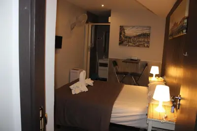 a bedroom with a bed with towels on it at BCN Condal Hostal in Barcelona