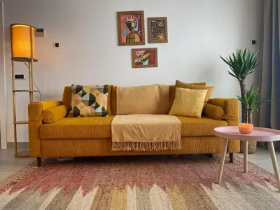 a brown couch in a living room with a table at Penthouse in Historic Sitges -Big Terrace & Private Solarium in Sitges