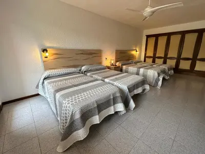 a bedroom with two beds and a ceiling at Casa L'Avi in Palau-Solità i Plegamans