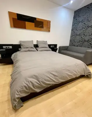 a bedroom with a large bed and a couch at Exclusiva Villa de Lujo con piscina in Canyelles