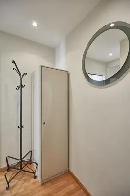 a mirror on a wall next to a door at BBarcelona Montjuic Apartment in Barcelona
