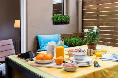 a table with a breakfast of oranges and juice at Bed&BCN Diagonal 2 in Barcelona