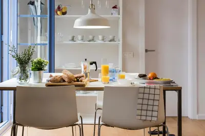 a kitchen with a table with food on it at Bed&BCN Diagonal 4 in Barcelona